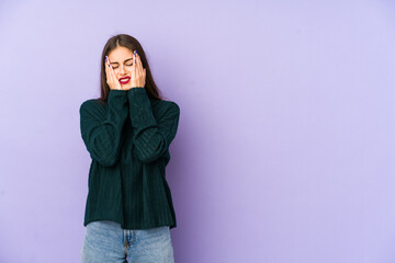 Young caucasian woman isolated on purple background whining and crying disconsolately.