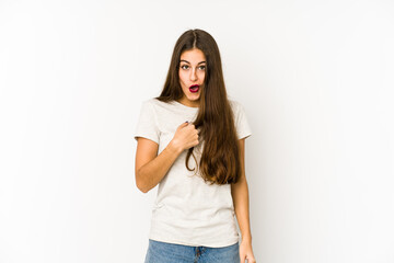 Young caucasian woman isolated on white background surprised pointing with finger, smiling broadly.