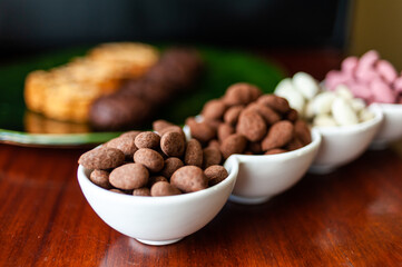 Almond nuts in dark, milk chocolate. 