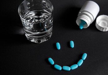 
Tablets with a glass of water and packaging