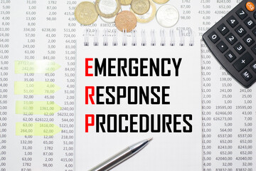 EMERGENCY RESPONSE PROCEDURES on the block on the background of financial reporting, coins, calculator, pens and yellow stickers. Business concept