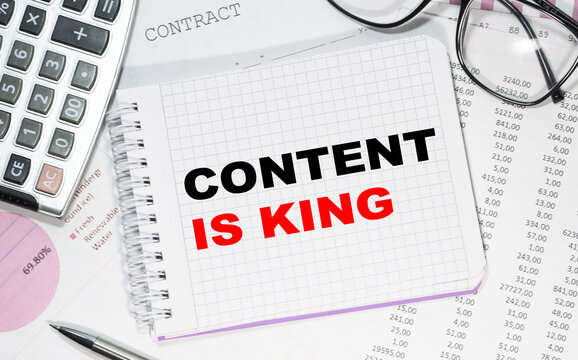 Business concept. Notebook with text CONTENT IS KING in your potential heet of white paper for notes, calculator, glasses, pencil, pen, in the white background