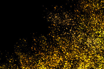 dark abstract grunge background of black color with yellow and orange paint spots, chaotically scattered.