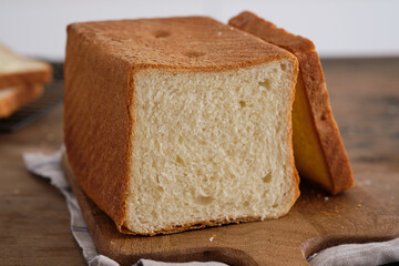 Wooden board with tasty homemade bread on the table.