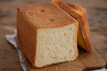 Wooden board with tasty homemade bread on the table.