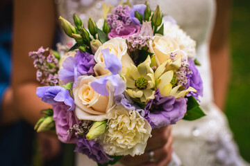 wedding bouquet of flowers in the hands of the bride