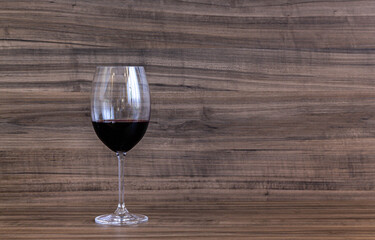 Glass of wine on wooden counter