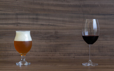 Glass of wine and glass of beer on a wooden bar counter