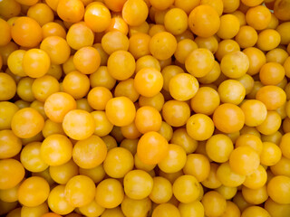 Juicy ripe yellow cherry plum, harvested in the summer in the garden. Closeup background
