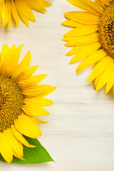 Frame made of Yellow sunflowers on white wooden background top view copy space. Beautiful fresh sunflowers, yellow flowers bouquet. Harvest time, farming Agriculture autumn or summer floral background