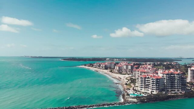 Amazing aerial view of Miami Beach coastline from drone on a sunny day, slow motion