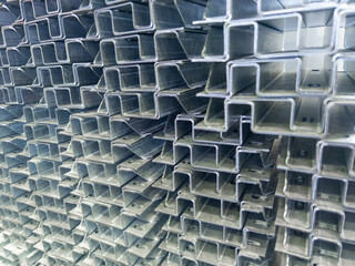 Full frame stack of bended zinc plated sheet metal parts - close-up with selective focus and blur....