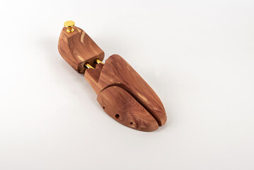 Wooden shoe lasts on a white background. Selective focus. Close-up.
