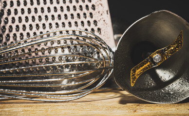 Close-up view of kitchen utensil. Kitchen grater, whisk and blender attachment.