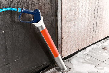 Car wash self-service station. Equipment for non-contact car wash. High pressure water jet washing gun.