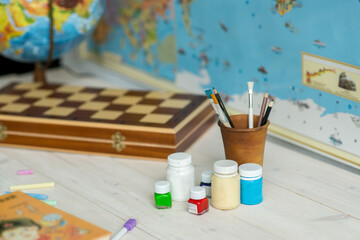 Brushes for drawing on a table with a globe. Schoolboy's Desk . Back to school. 