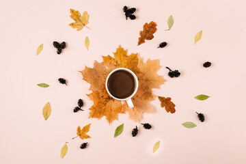 Flat lay composition with dry leaves, cup coffee, little cones on pink color background. Creative autumn, thanksgiving, fall, halloween concept. Top view, copy space