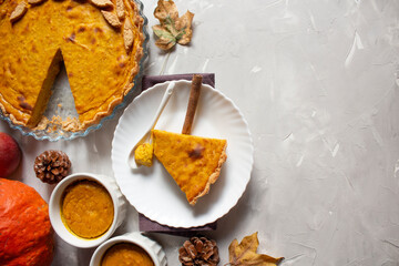 Homemade delicious pumpkin pie on a gray background. Thanksgiving dessert. Thanksgiving pumpkin. traditional homemade pumpkin pie for the fall holiday.
