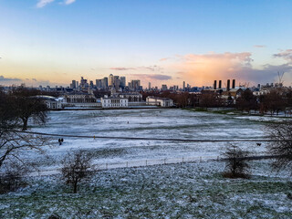Greenwich obervatory college hill walk park snow winter evening sunset orange warm light clouds view London city skyline