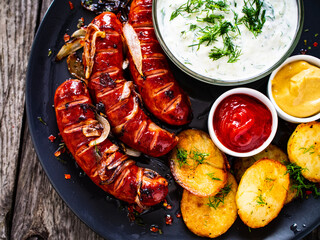 Grilled sausages on wooden board
 - obrazy, fototapety, plakaty