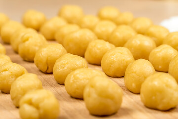 Small balls of fresh homemade cookie dough on a wooden Board, macro, background