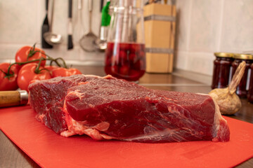 a piece of beef on a table with a knife
