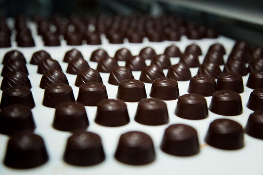 Sweets factory. Sweets production process. Conveyor belt with sweets on it.