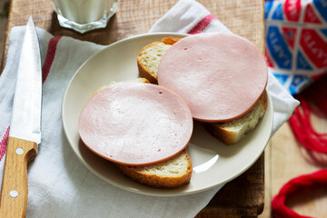 Sandwiches made of bread and boiled sausage, served with milk.