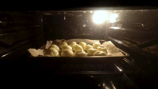 Timelapse of baking profiteroles in an electric oven