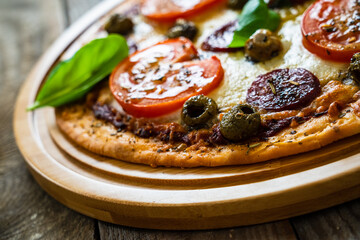 Margherita pizza on wooden background
