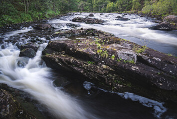 Fototapeta premium Water cascades on the river Garry, Scotland, UK. Strong water flow in beautiful and clean nature
