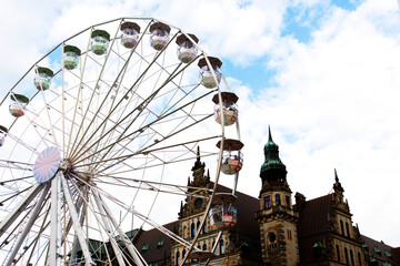 Fototapeta premium Colourful ferris wheel behind a historical building at Bremen Germany