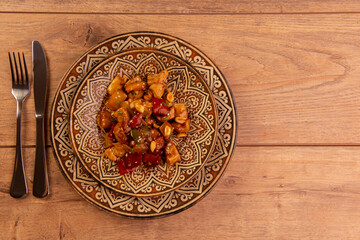 chess chicken in brown dish on wooden background - chinese food