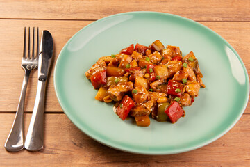 chess chicken in green dish on wooden background - chinese food
