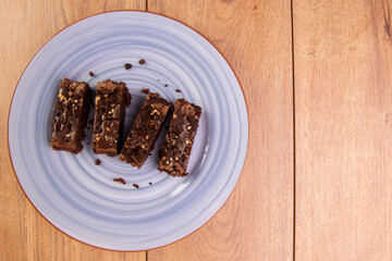 some brownie slices on a plate on wooden table