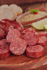Grilled sliced ausage on wooden board - Brazilian barbecue