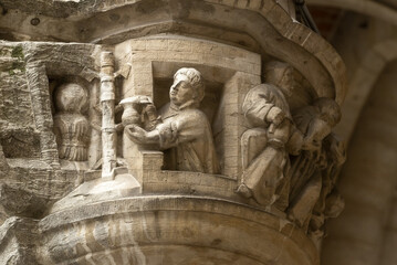 historiated lamp-heads depicting tragic scenes involving aldermen on the Grand Place in Brussels, Belgium
