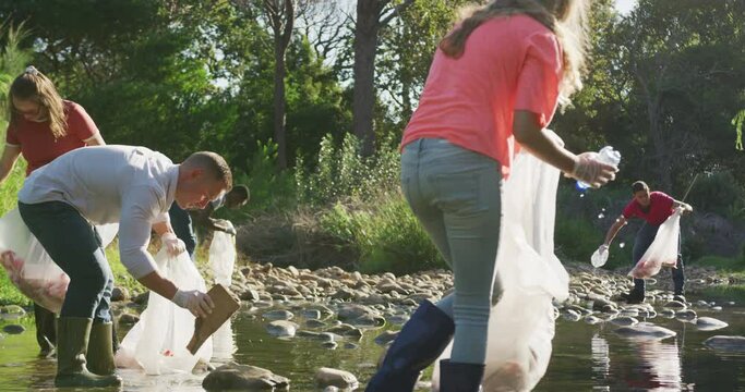Mid adults volunteering during river clean-up day