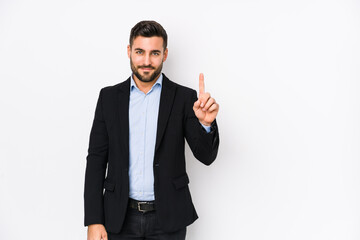 Young caucasian business man against a white background isolated showing number one with finger.