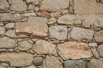 Rustic beige old stone wall