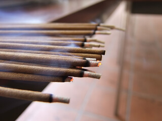 Close up shot of many incense sticks burning