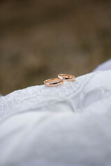 gold rings on the white cushion to be worn at the wedding