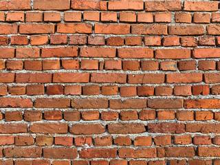 Old brick wall background with cracked and broken bricks