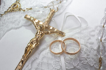 gold rings and cross on the wedding cushion