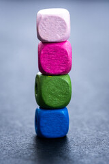 Stack of bright wooden beads on gray background