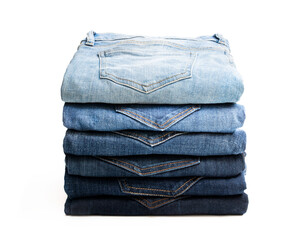 Lot of various used women jeans stacked in a pile isolated on white