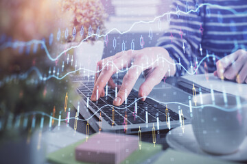 Double exposure of woman hands typing on computer and forex chart hologram drawing. Stock market invest concept.