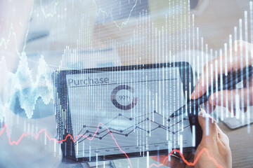 Double exposure of man's hands holding and using a phone and financial chart drawing. Market analysis concept.