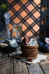 fig with Camembert cheese and honey.   Wine and cheese still life.