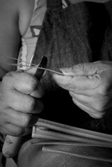 Craftsman hands sewing working with vegetable fiber